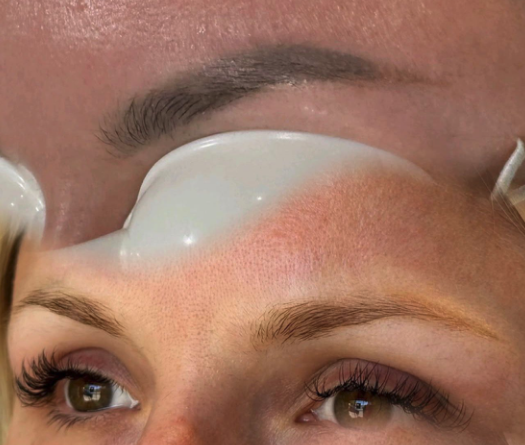 Carbon facial skin treatment being performed on a client